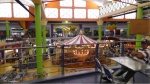 There is a huge two story food court with a merry go round in the middle